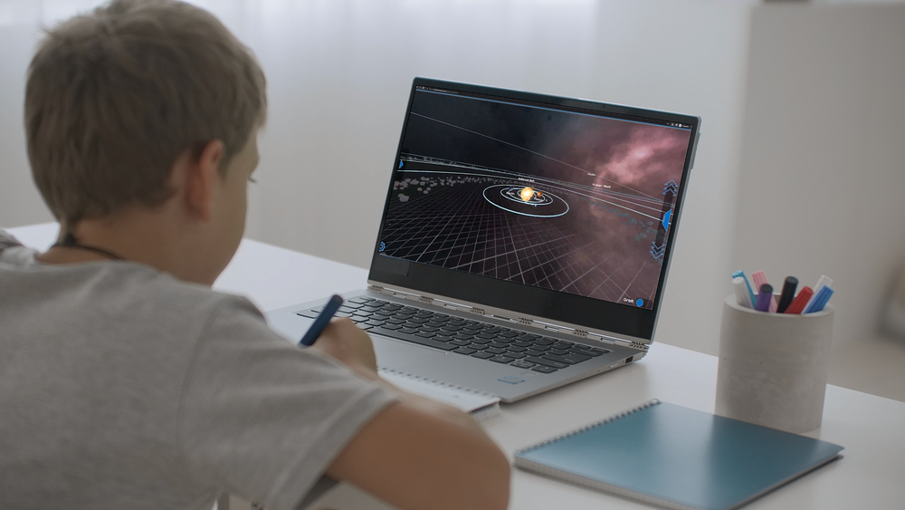 A homeschool student exploring the solar system on a laptop